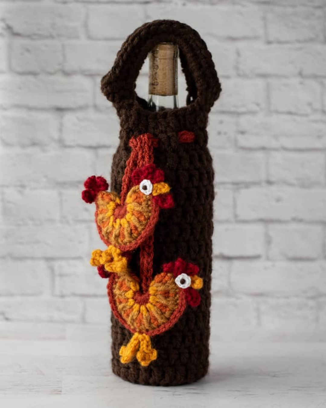 brown crochet wine bottle holder with rooster appliques